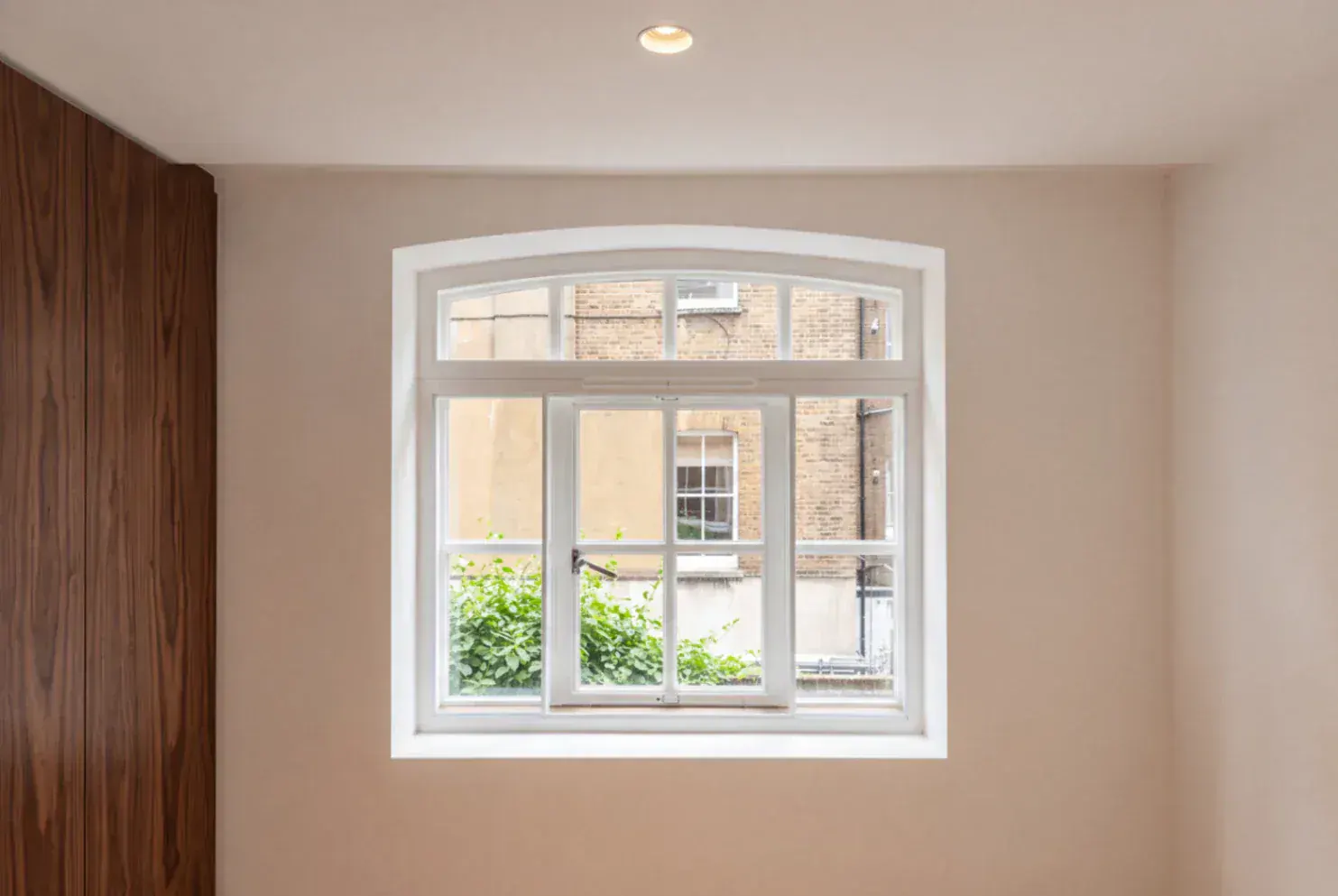 Secondary glazing in a period window with an arched fanlight