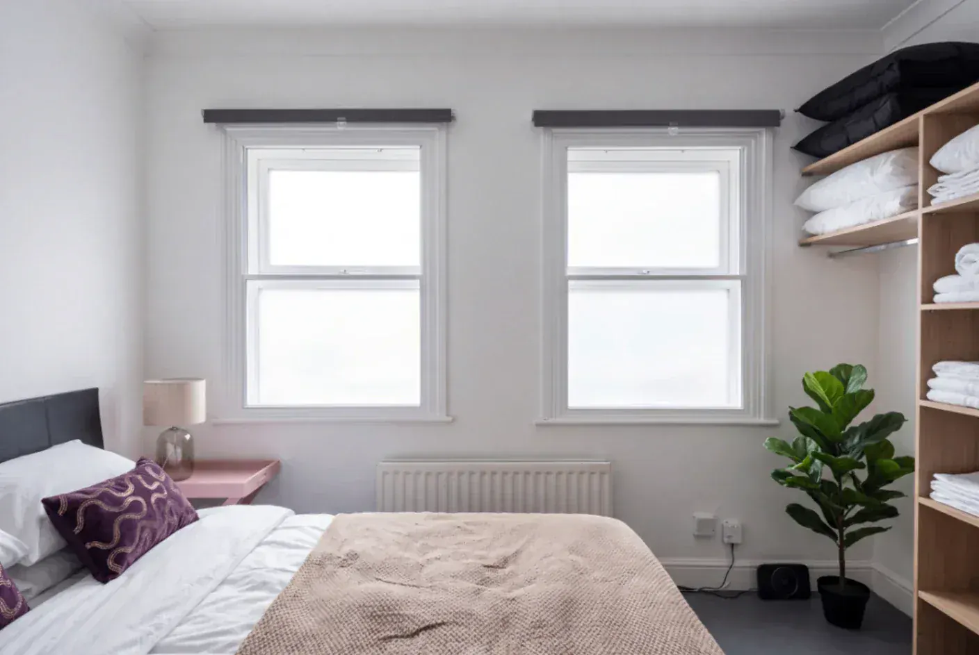 Secondary glazing in a bedroom with two windows
