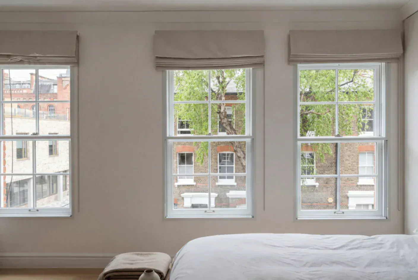 Secondary glazing across three sash windows in a bedroom