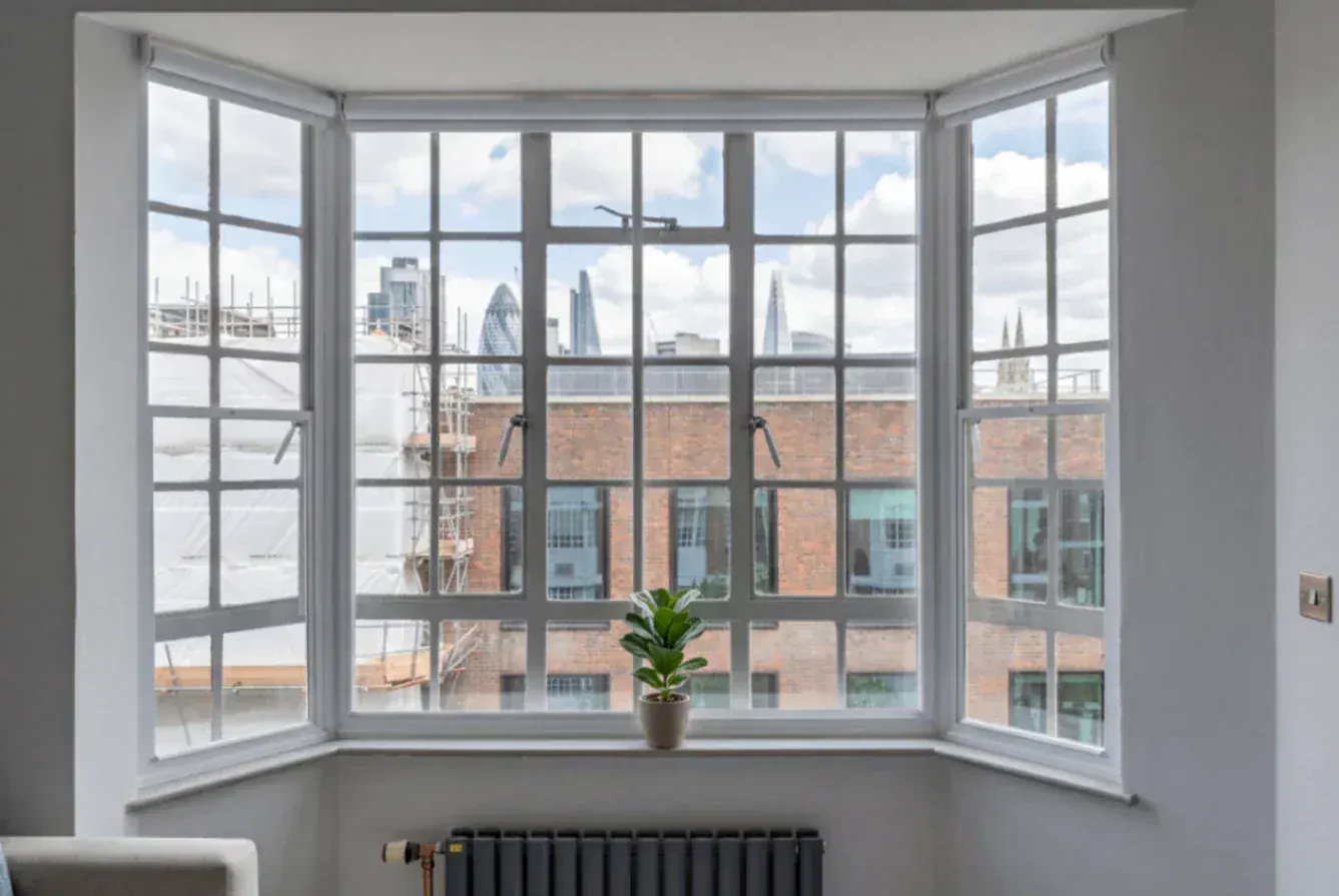 Secondary glazing around a bay window overlooking city buildings