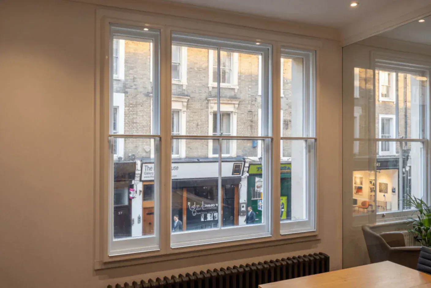 Secondary glazing across windows in a commercial interior