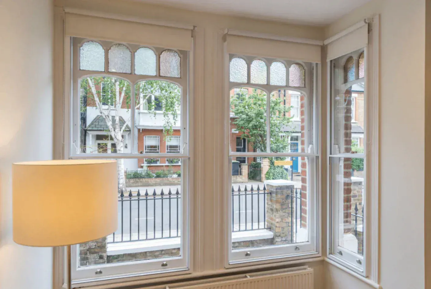 Secondary glazing around a bay window with arched panes