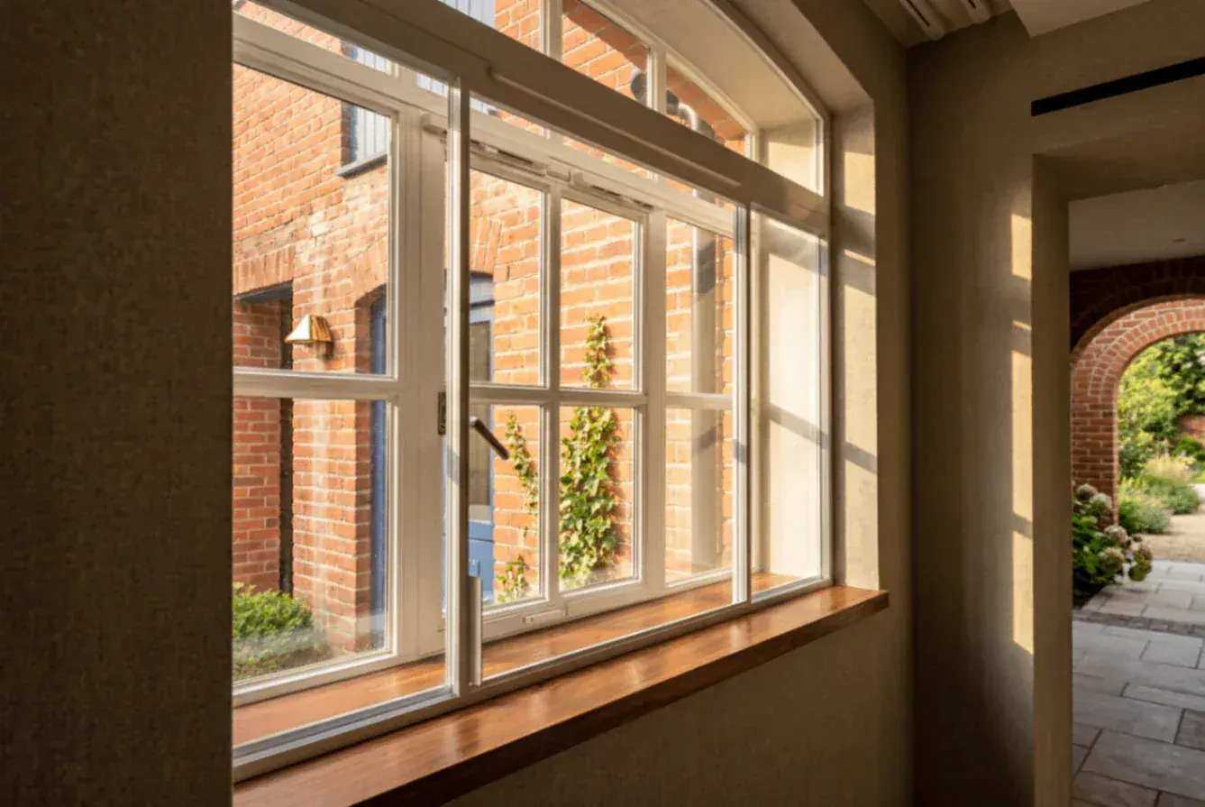 Secondary glazing in a room overlooking a brick courtyard