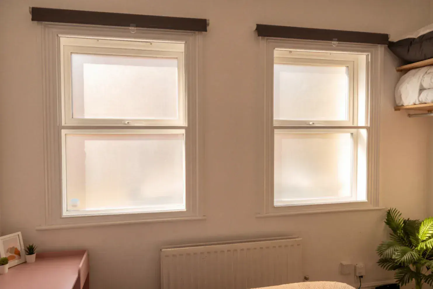 Secondary glazing in a bedroom with two windows