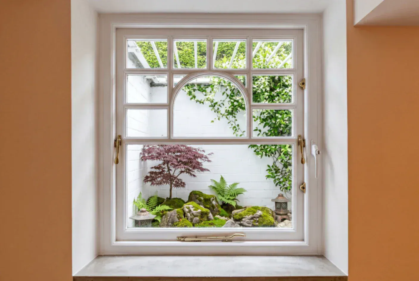 Secondary glazing in a period window with an arched pane