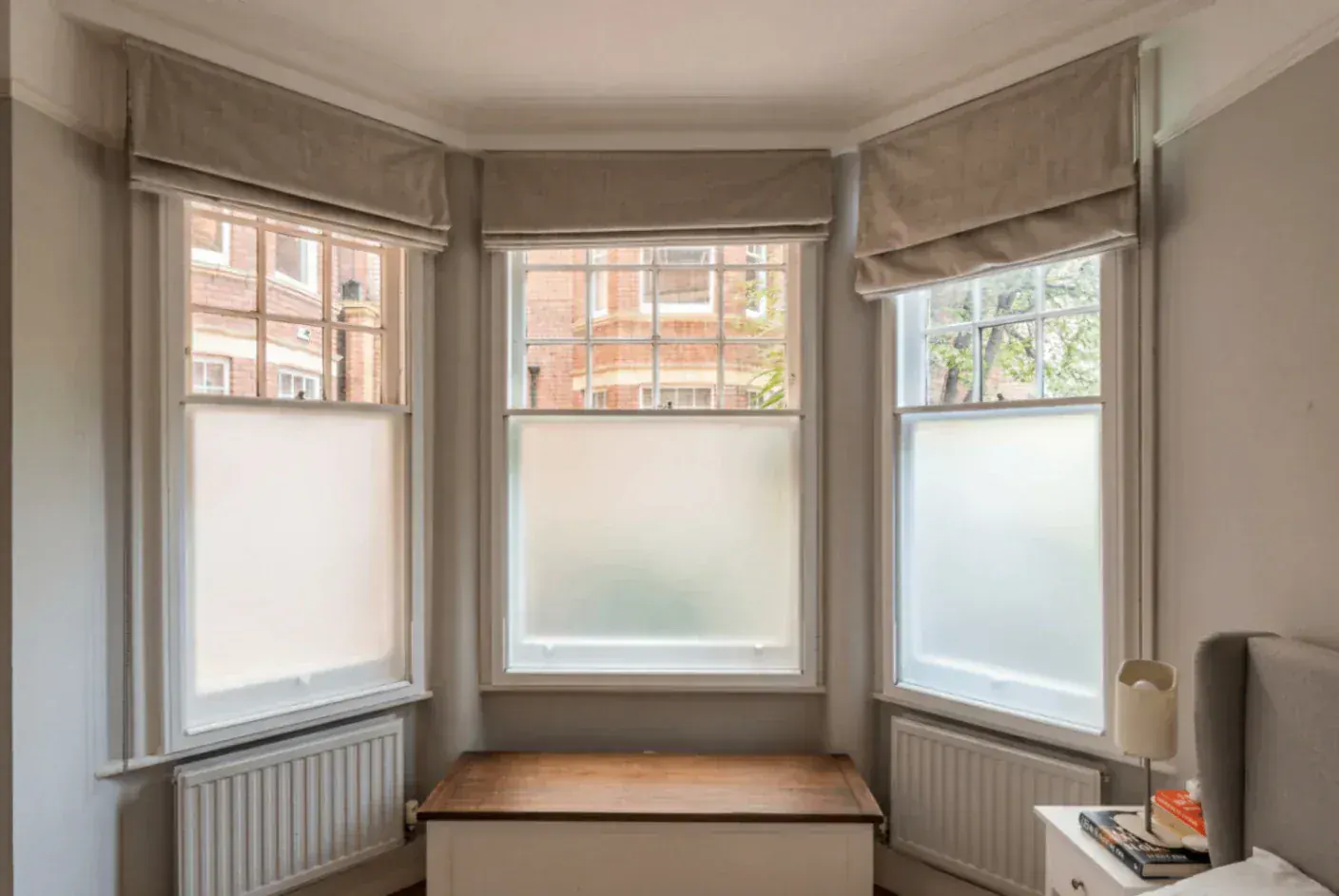 Secondary glazing around a bay window with blinds